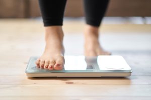 woman's foot stepping on a scale